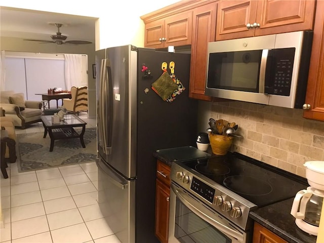 620 E Lake Jasmine Cir Unit 102, Vero Beach, FL 32962 - kitchen featuring appliances with stainless steel finishes, a ceiling fan, decorative backsplash, light tile patterned floors, and open floor plan