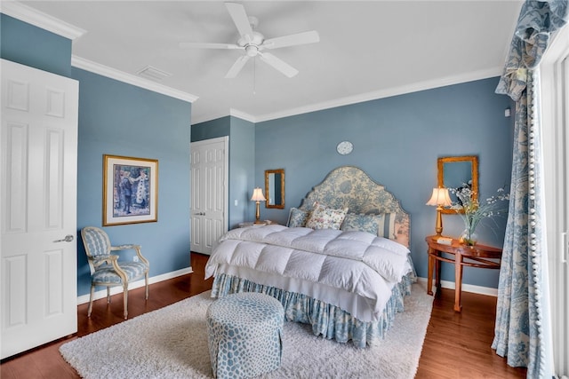 bedroom featuring ceiling fan, crown molding, a closet, and dark hardwood / wood-style flooring