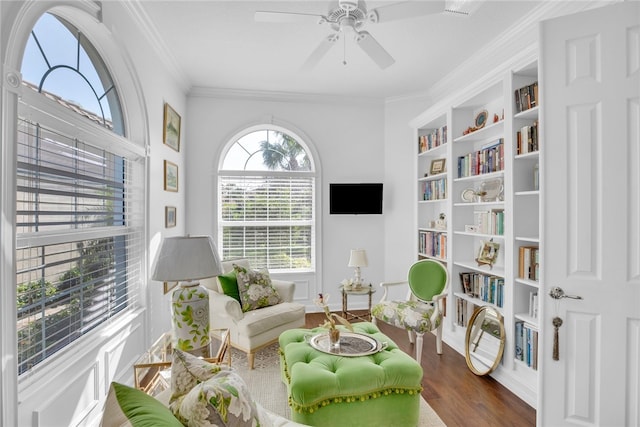 sitting room with ceiling fan, dark hardwood / wood-style floors, and ornamental molding