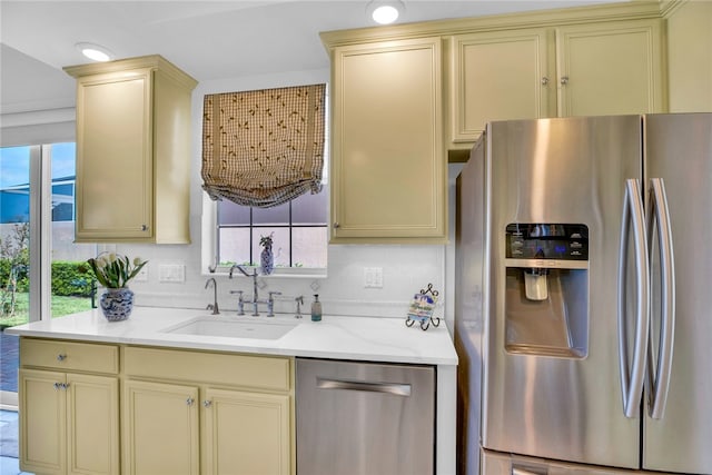 kitchen with decorative backsplash, sink, light stone counters, and stainless steel appliances