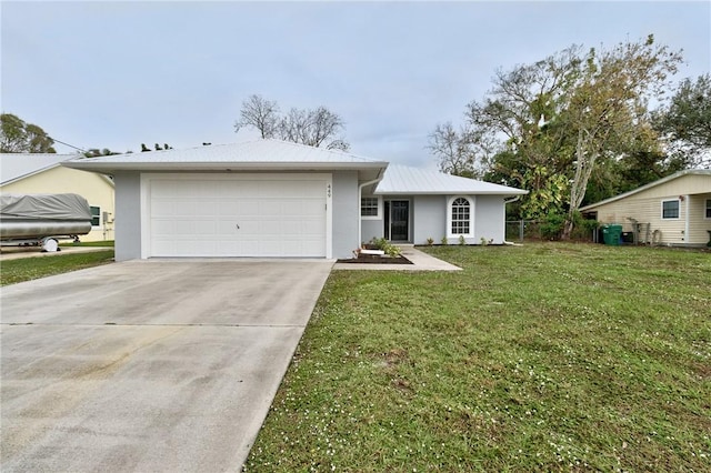 ranch-style home featuring a garage and a front lawn