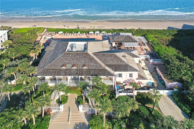 bird's eye view featuring a water view and a beach view