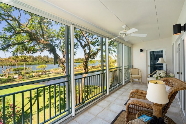 sunroom with a water view and ceiling fan