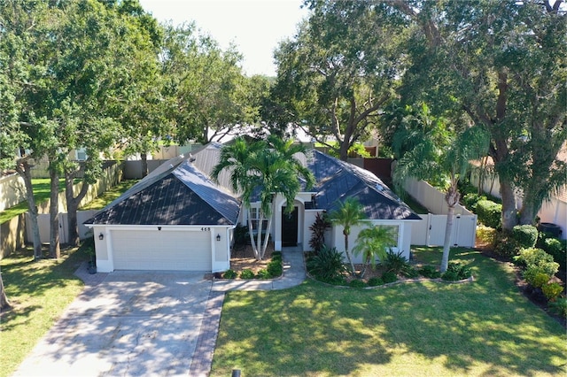 obstructed view of property featuring a garage and a front yard