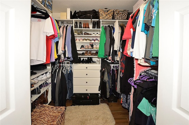 walk in closet featuring dark wood-type flooring