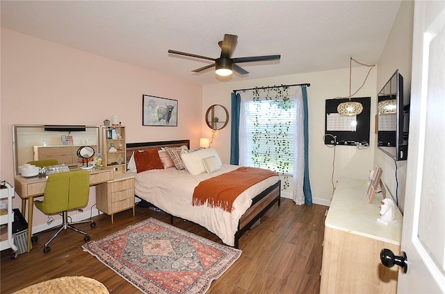 bedroom featuring dark wood-type flooring and ceiling fan