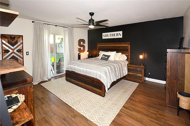 bedroom with ceiling fan, access to exterior, a textured ceiling, and hardwood / wood-style floors