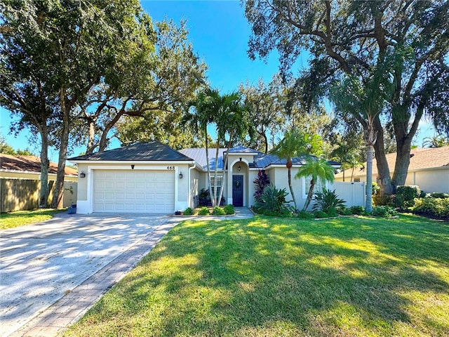 ranch-style home with a garage and a front lawn