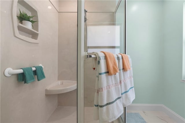 bathroom with a shower with door