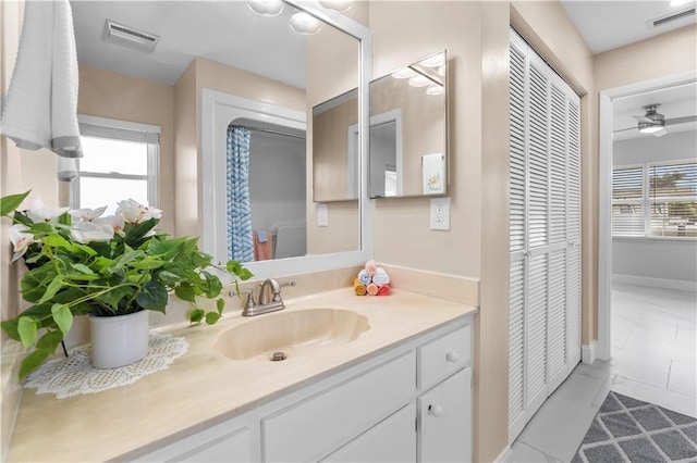 bathroom featuring vanity, ceiling fan, tile patterned floors, and plenty of natural light