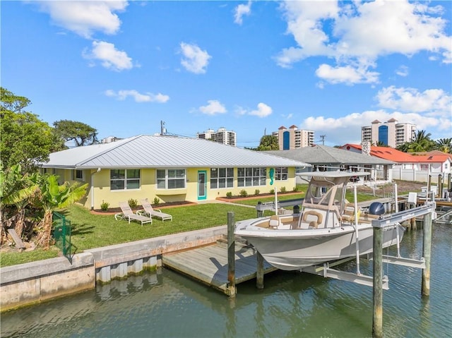 dock area with a water view and a yard