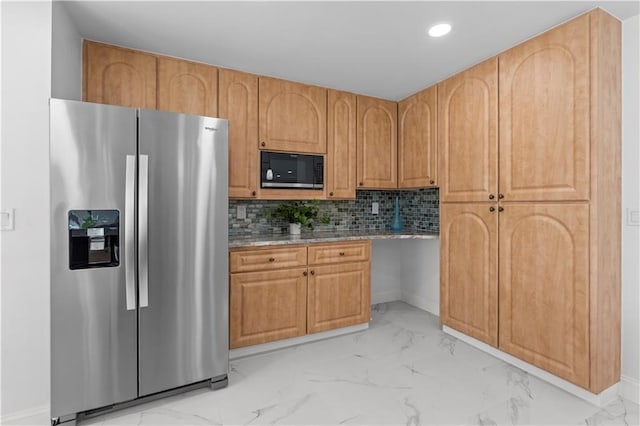 kitchen with stainless steel refrigerator with ice dispenser, decorative backsplash, and black microwave