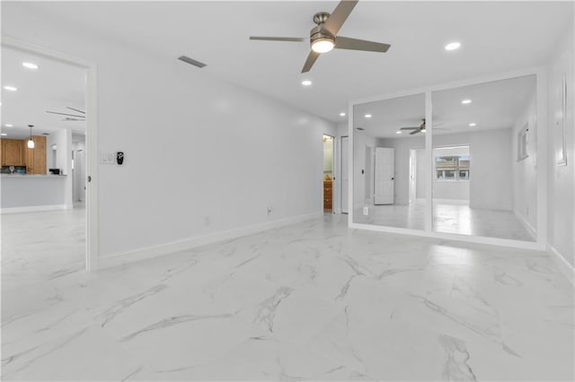 unfurnished living room with ceiling fan