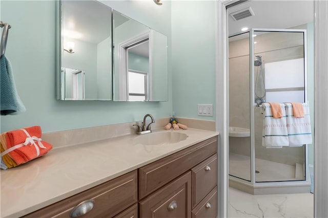 bathroom featuring vanity and a shower with door