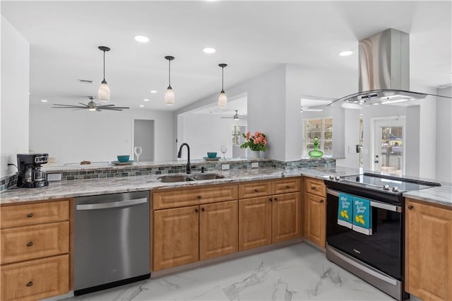 kitchen featuring decorative light fixtures, stainless steel appliances, sink, island range hood, and light stone counters