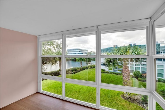 unfurnished sunroom with a water view