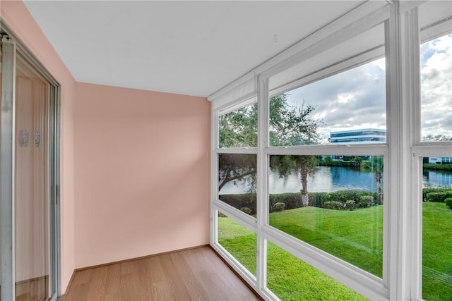 unfurnished sunroom with a water view