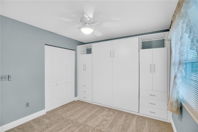 unfurnished bedroom featuring ceiling fan and light colored carpet