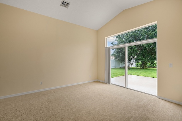 unfurnished room with light colored carpet and lofted ceiling