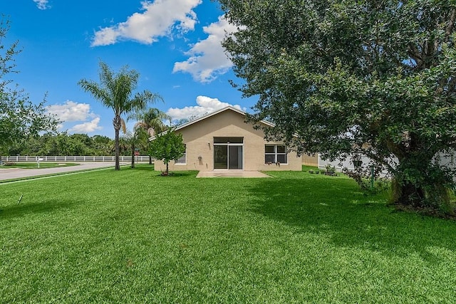 back of house featuring a yard and a patio area