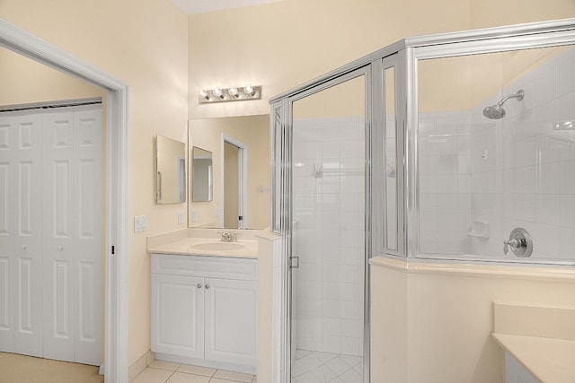 bathroom with tile patterned floors, vanity, and an enclosed shower