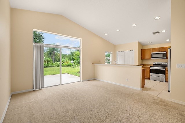 unfurnished living room featuring sink, light carpet, and vaulted ceiling