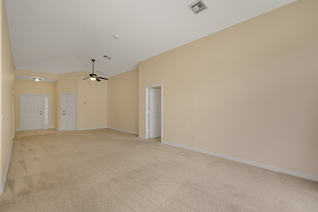 spare room with a textured ceiling, light colored carpet, high vaulted ceiling, and ceiling fan