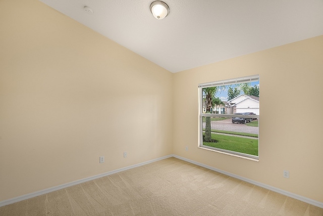 empty room featuring carpet floors and lofted ceiling