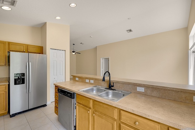 kitchen featuring light tile patterned floors, stainless steel appliances, ceiling fan, and sink