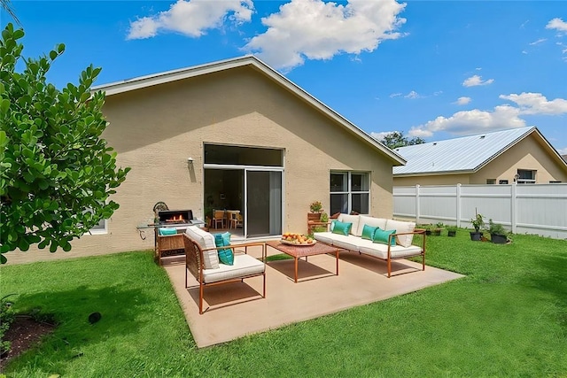 rear view of house featuring a lawn, outdoor lounge area, and a patio