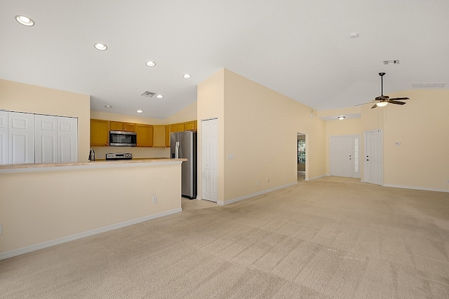 unfurnished living room with ceiling fan, high vaulted ceiling, and light carpet