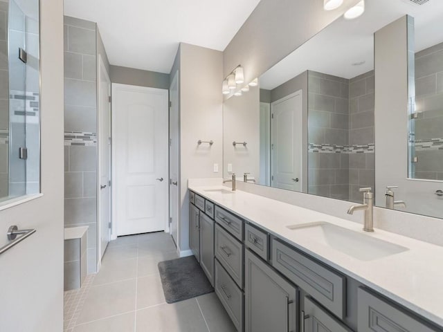 bathroom featuring tile patterned flooring, vanity, and a shower