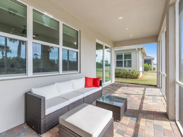 sunroom with a healthy amount of sunlight and ceiling fan