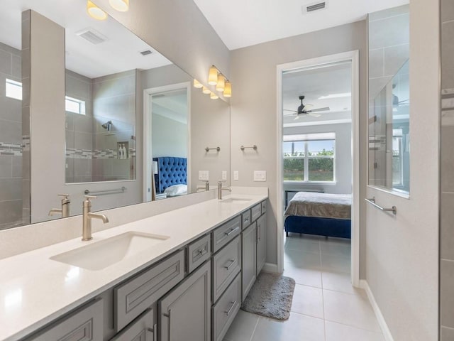 bathroom featuring vanity, a tile shower, tile patterned floors, and ceiling fan