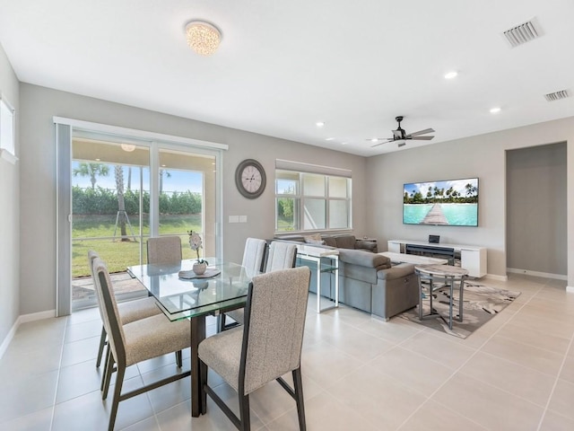 tiled dining space with ceiling fan