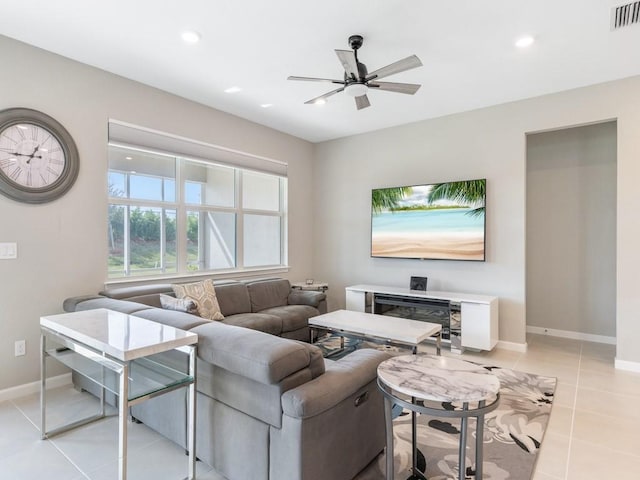 tiled living room featuring ceiling fan