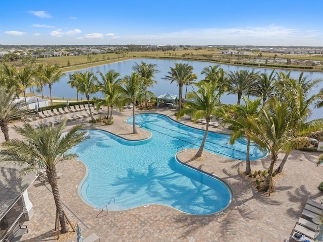 view of pool with a patio area and a water view