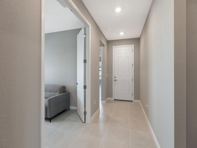 hall with light tile patterned floors