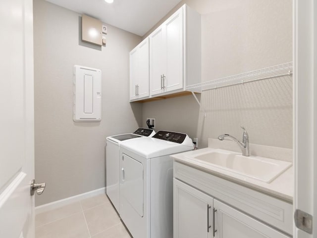 clothes washing area with sink, cabinets, light tile patterned floors, electric panel, and washing machine and dryer