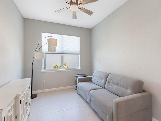 living area with ceiling fan and light tile patterned floors