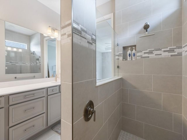 bathroom featuring vanity and tiled shower