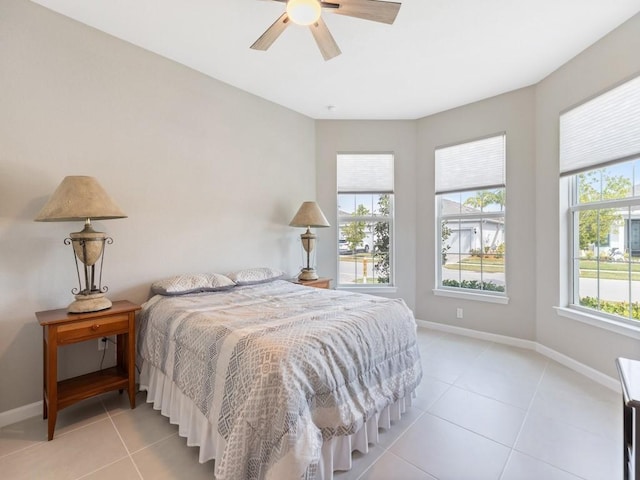 bedroom with ceiling fan and light tile patterned floors