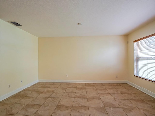 1544 Par Ct, Vero Beach, FL 32966 - unfurnished room featuring baseboards and a textured ceiling