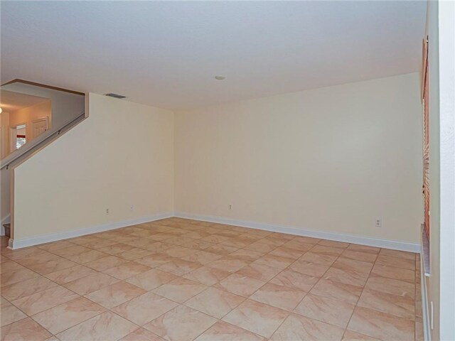 1544 Par Ct, Vero Beach, FL 32966 - empty room featuring stairs and baseboards