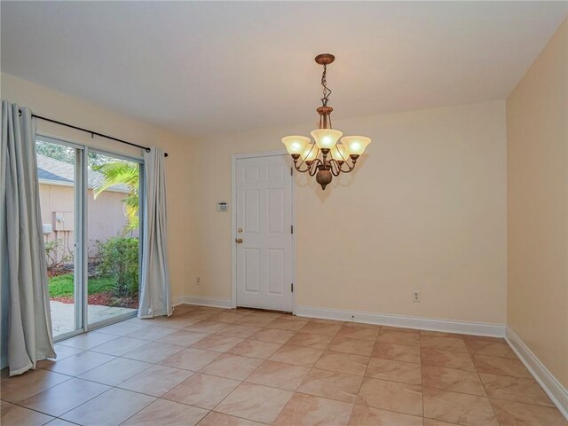 1544 Par Ct, Vero Beach, FL 32966 - spare room with a chandelier and light tile patterned flooring