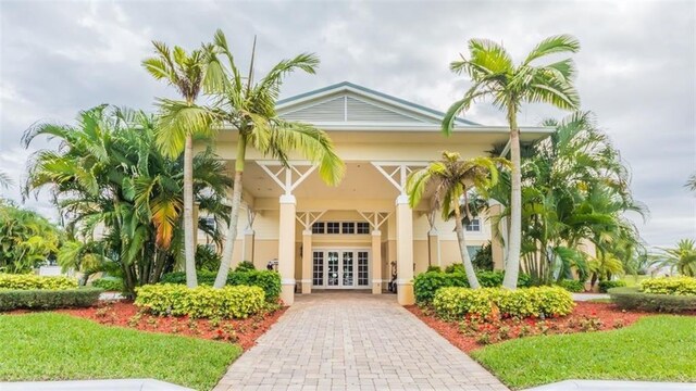 1544 Par Ct, Vero Beach, FL 32966 - doorway to property with french doors, driveway, and stucco siding