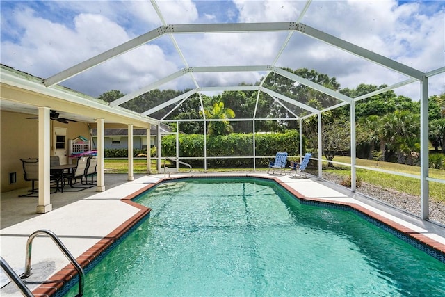 outdoor pool with a patio area, ceiling fan, and a lanai