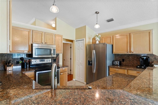kitchen featuring dark stone countertops, visible vents, and appliances with stainless steel finishes
