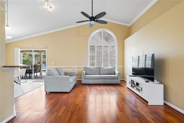 living room with lofted ceiling, a ceiling fan, crown molding, and wood finished floors