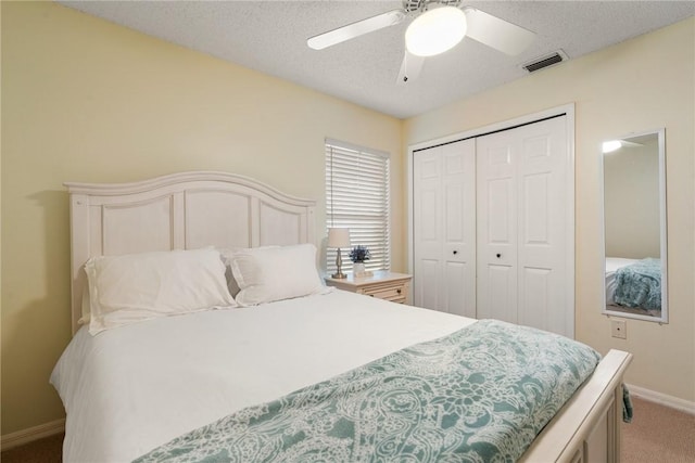bedroom featuring a closet, baseboards, light carpet, a ceiling fan, and visible vents